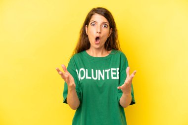 pretty caucasian woman feeling extremely shocked and surprised. enviromental volunteer concept