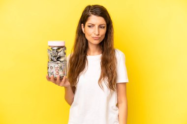 pretty caucasian woman feeling sad, upset or angry and looking to the side. dollar banknotes savings