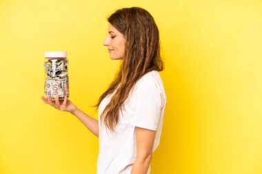 pretty caucasian woman on profile view thinking, imagining or daydreaming. dollar banknotes savings