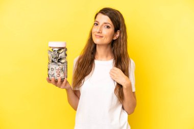 pretty caucasian woman looking arrogant, successful, positive and proud. dollar banknotes savings