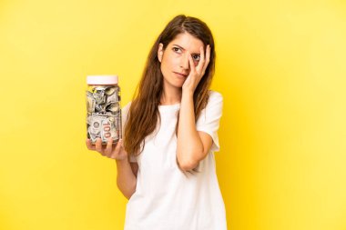pretty caucasian woman feeling bored, frustrated and sleepy after a tiresome. dollar banknotes savings