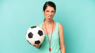 pretty caucasian woman feeling disgusted and irritated and tongue out. soccer trainer concept
