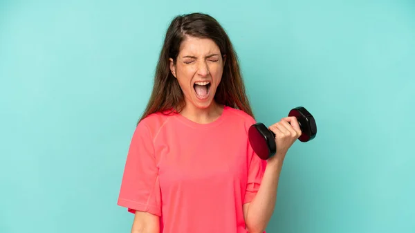 Pretty Caucasian Woman Shouting Aggressively Looking Very Angry Fitness Dumbbell —  Fotos de Stock