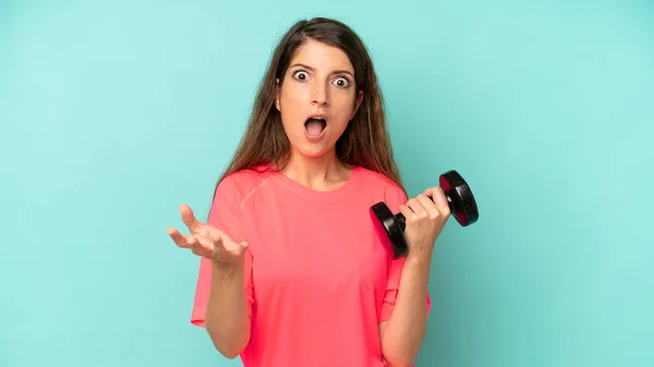 Pretty Caucasian Woman Feeling Extremely Shocked Surprised Fitness Dumbbell Concept — Zdjęcie stockowe