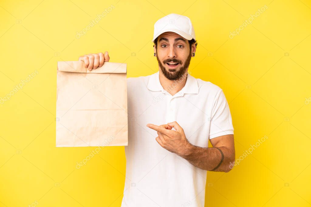 crazy bearded man looking excited and surprised pointing to the side. take away concept delivering