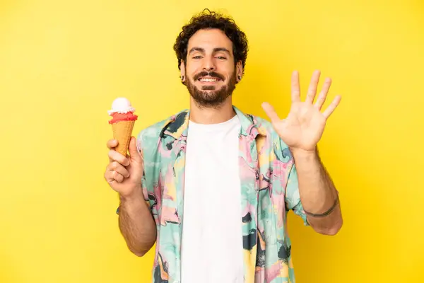 crazy bearded man smiling and looking friendly, showing number five. ice cream and summer concept