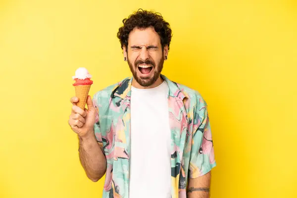 crazy bearded man shouting aggressively, looking very angry. ice cream and summer concept
