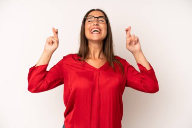 İspanyol güzel kadın gülümsüyor ve endişeyle iki parmağını çapraz yapıyor. Endişeli hissediyor, iyi şanslar diliyor ya da umut ediyor.