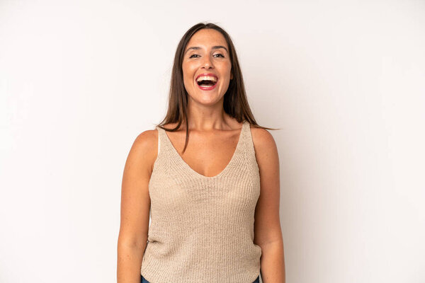 hispanic pretty woman looking happy and pleasantly surprised, excited with a fascinated and shocked expression