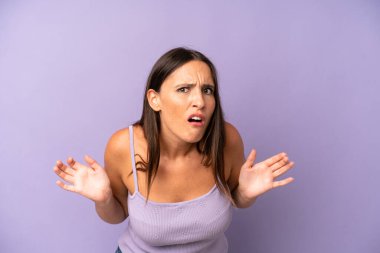 hispanic pretty woman feeling clueless and confused, having no idea, absolutely puzzled with a dumb or foolish look