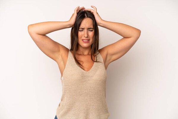 hispanic pretty woman feeling stressed and frustrated, raising hands to head, feeling tired, unhappy and with migraine