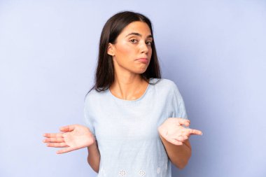 hispanic pretty woman feeling clueless and confused, having no idea, absolutely puzzled with a dumb or foolish look