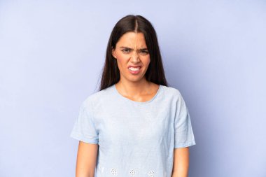 hispanic pretty woman feeling puzzled and confused, with a dumb, stunned expression looking at something unexpected