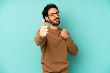 Genç sakallı adam gururlu, kaygısız, kendinden emin ve mutlu, olumlu gülümsüyor.