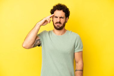 Genç sakallı adam şaşkın ve şaşkın hissediyor. Deli, deli ya da aklını kaçırmış olduğunu gösteriyor.