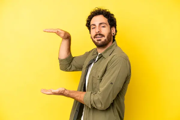 Young Bearded Man Holding Object Both Hands Side Copy Space — Stock Photo, Image