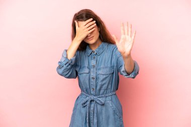 Genç ve güzel bir kadın yüzünü eliyle kapatıyor ve kamerayı durdurmak için diğer elini öne koyuyor. Fotoğraf ya da resimleri reddediyor.