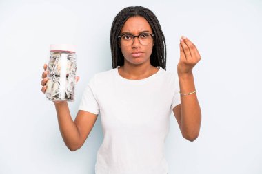 black pretty woman making capice or money gesture, telling you to pay. savings concept
