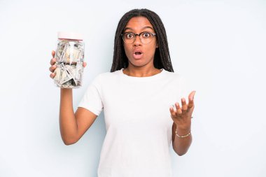 black pretty woman amazed, shocked and astonished with an unbelievable surprise. savings concept