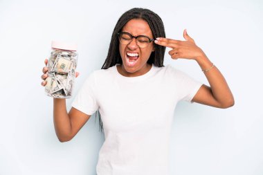 black pretty woman looking unhappy and stressed, suicide gesture making gun sign. savings concept