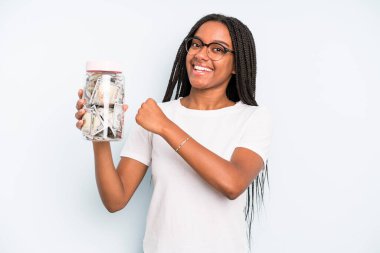 black pretty woman feeling happy and facing a challenge or celebrating. savings concept