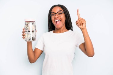 black pretty woman feeling like a happy and excited genius after realizing an idea. savings concept