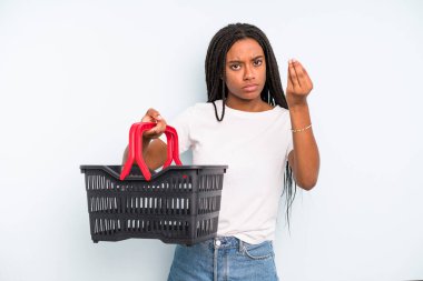 black pretty woman making capice or money gesture, telling you to pay. empty shopping basket