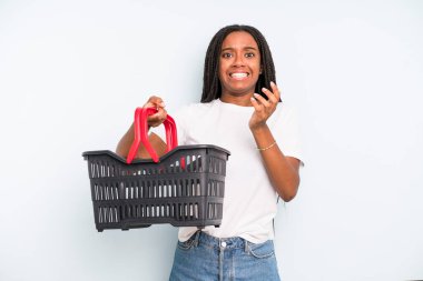 black pretty woman looking desperate, frustrated and stressed. empty shopping basket