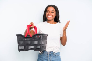 black pretty woman feeling happy, surprised realizing a solution or idea. empty shopping basket