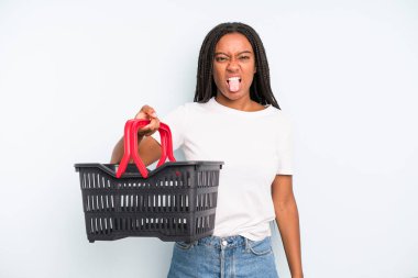 black pretty woman feeling disgusted and irritated and tongue out. empty shopping basket