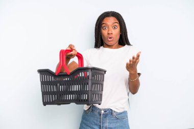 black pretty woman feeling extremely shocked and surprised. empty shopping basket