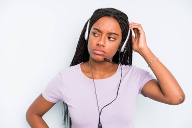 black pretty woman feeling puzzled and confused, scratching head. telemarketer concept