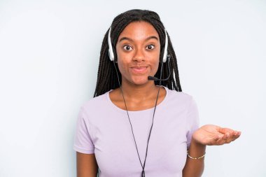 black pretty woman feeling puzzled and confused and doubting. telemarketer concept