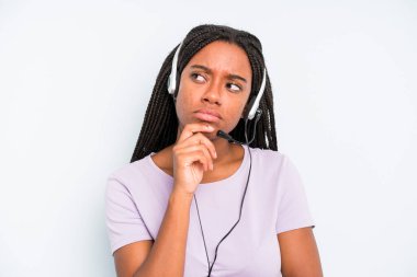 black pretty woman thinking, feeling doubtful and confused. telemarketer concept