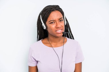 black pretty woman feeling puzzled and confused. telemarketer concept