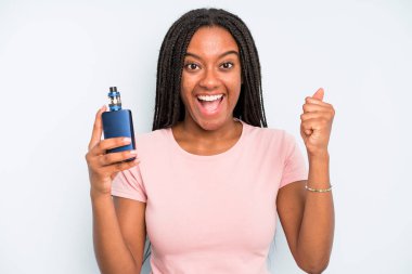 black pretty woman feeling shocked,laughing and celebrating success. smoker vaper concept