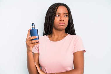 black pretty woman shrugging, feeling confused and uncertain. smoker vaper concept