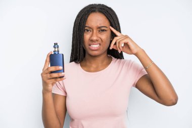 black pretty woman feeling confused and puzzled, showing you are insane. smoker vaper concept