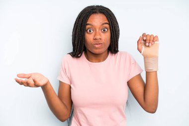 black pretty woman feeling puzzled and confused and doubting. broken hand concept