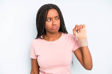 black pretty woman feeling sad, upset or angry and looking to the side. broken hand concept