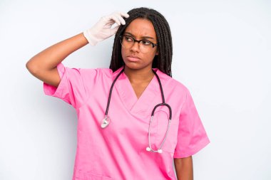 black pretty woman smiling happily and daydreaming or doubting. nurse concept