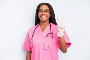 black pretty woman smiling and looking happy, gesturing victory or peace. nurse concept