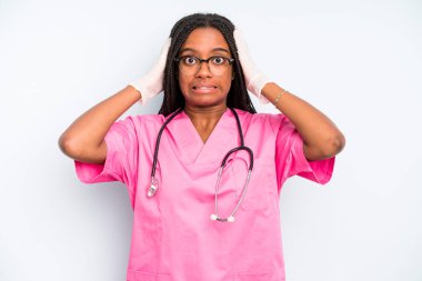 black pretty woman feeling stressed, anxious or scared, with hands on head. nurse concept