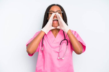 black pretty woman feeling happy,giving a big shout out with hands next to mouth. nurse concept