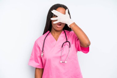 black pretty woman looking shocked, scared or terrified, covering face with hand. nurse concept