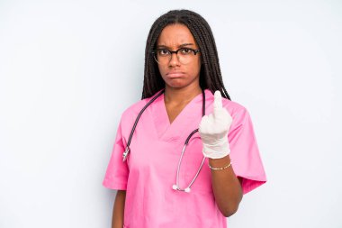 black pretty woman feeling angry, annoyed, rebellious and aggressive. nurse concept