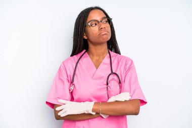 black pretty woman shrugging, feeling confused and uncertain. nurse concept