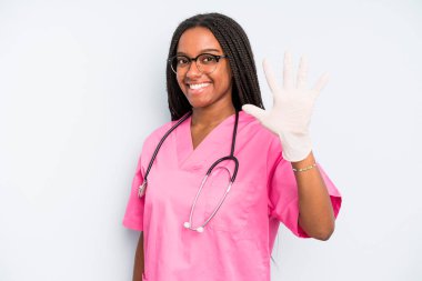 black pretty woman smiling and looking friendly, showing number five. nurse concept