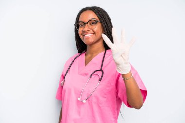black pretty woman smiling and looking friendly, showing number four. nurse concept