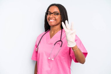 black pretty woman smiling and looking friendly, showing number three. nurse concept